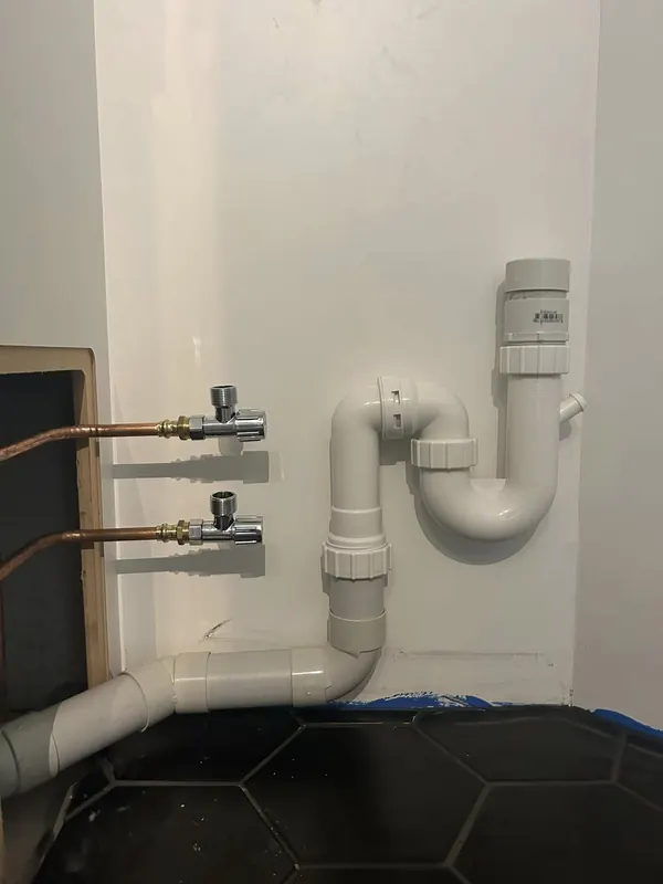 New basin waste, trap and isolation stop taps installed under a vanity