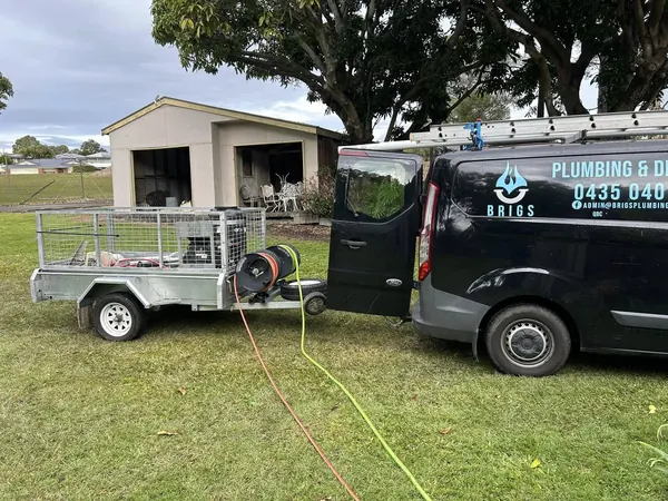 The Brigs Plumbing van and jetter trailer set up on site