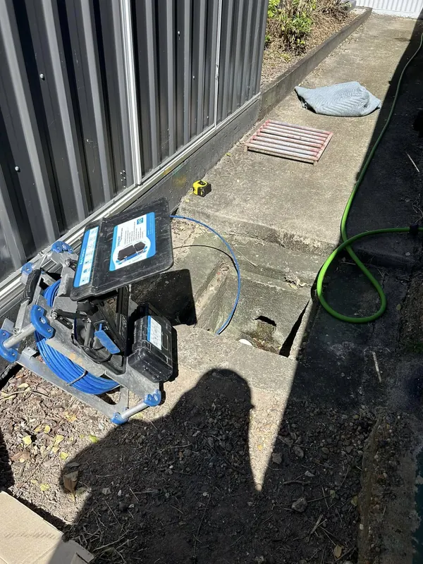 Drain camera reel and monitor set up on a driveway for an underground inspection