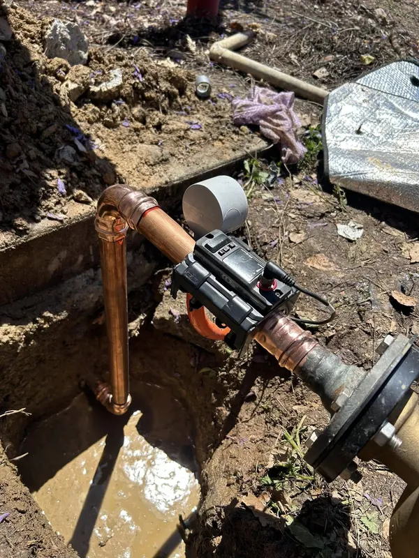 Excavated drain with the camera reel alongside during a repair