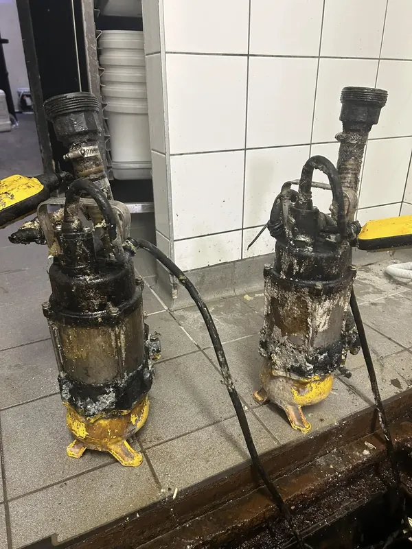 Two failed submersible sewage pumps removed from a pump station