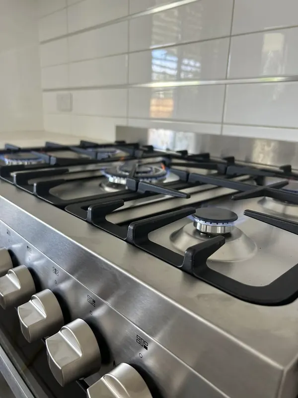 Stainless gas cooktop installed in a kitchen benchtop