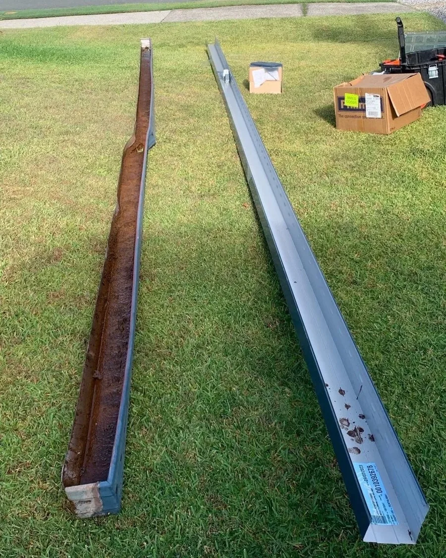 Rusted original gutter beside its new steel replacement during a gutter renewal in Rochedale South