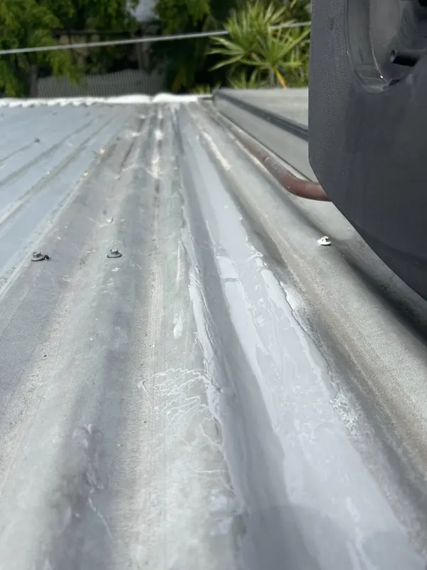 Corrugated metal roof sheeting after roof plumbing work
