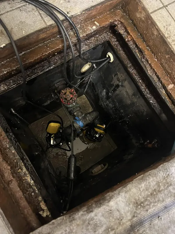 Working inside a pump station pit during a service