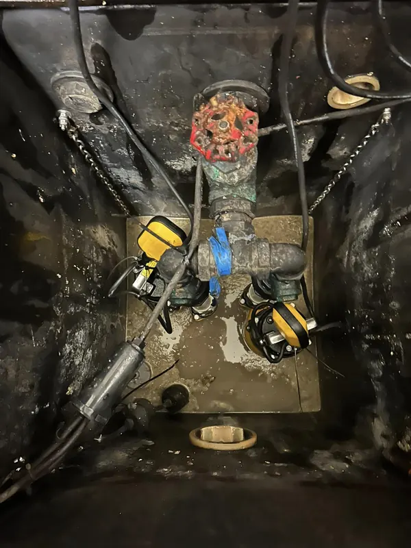 Valves and rising main inside a pump station chamber