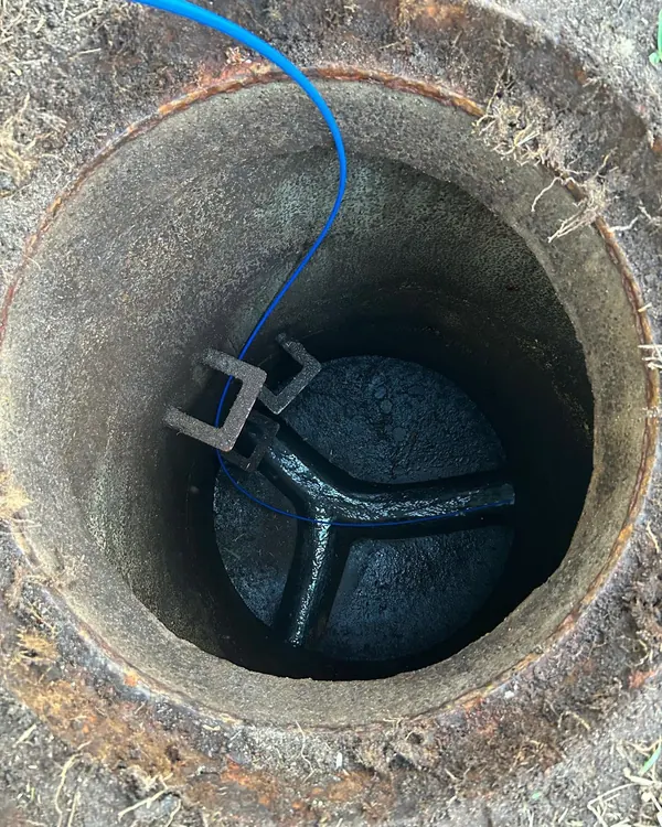 Looking down into a concrete sewer inspection chamber at the junction below
