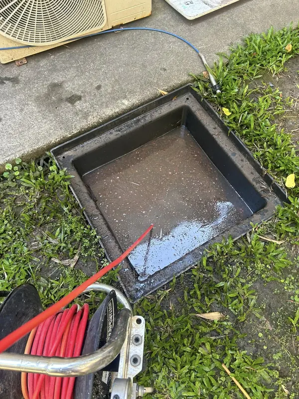 Surface drainage pit set into a lawn during a stormwater repair