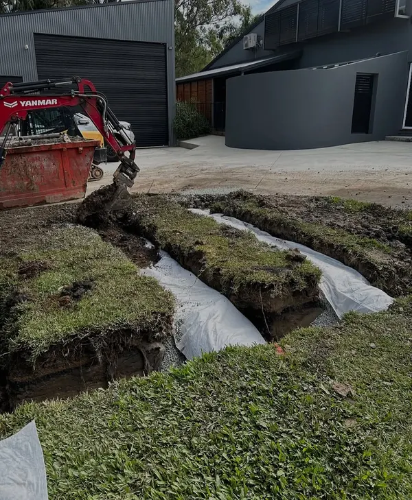 Trench line across a lawn after an underground drain replacement